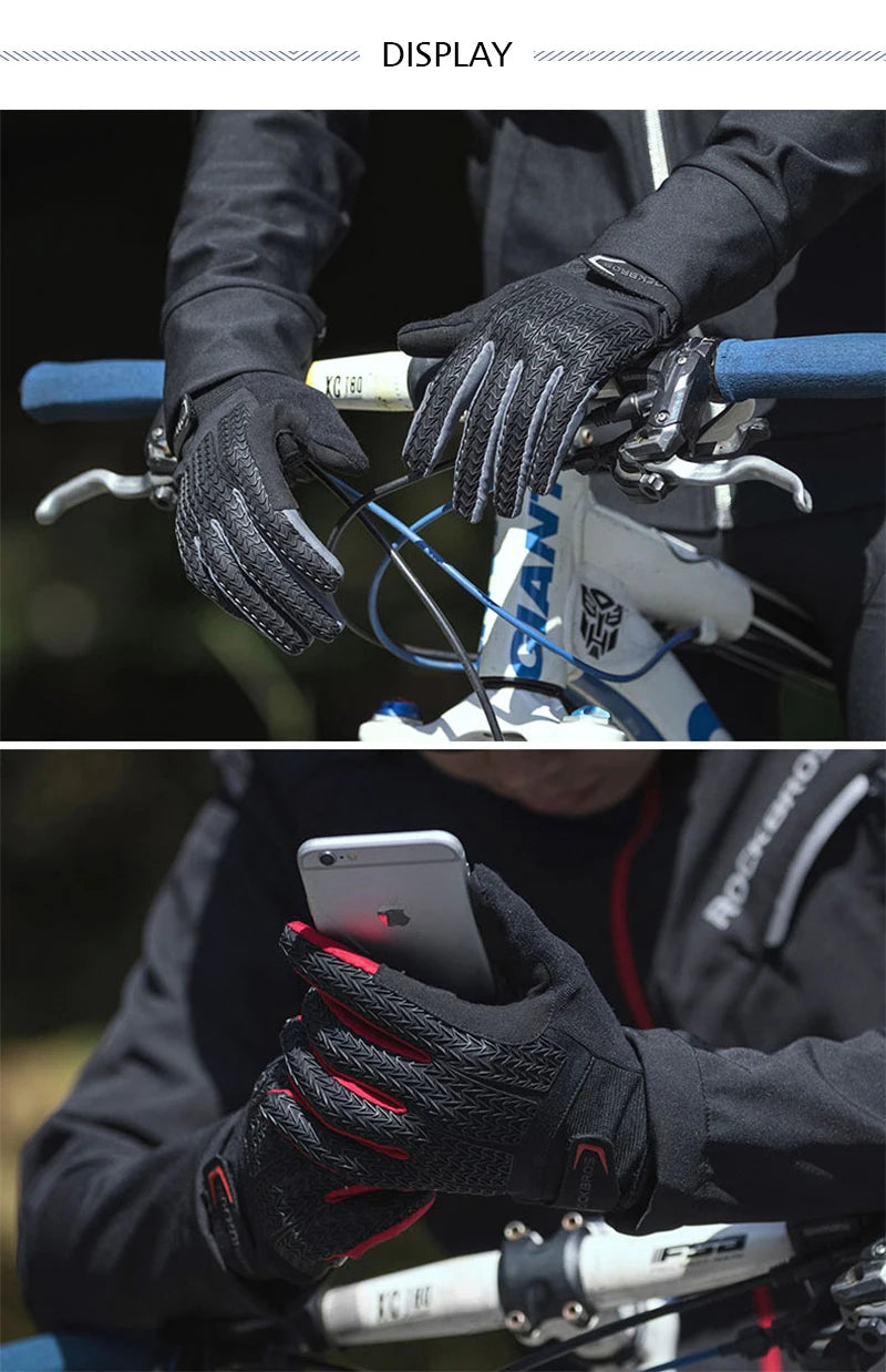 Close-up of hands wearing black cycling gloves gripping a bicycle handlebar and displaying a smartphone.