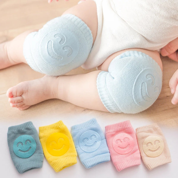 A collection of soft elastic leg warmers in various pastel colors, including blue, yellow, purple, and pink, laid out on a wo