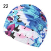 A close-up view of a blue and pink floral patterned elastic nylon turban swimming cap.