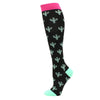Black compression socks with a pink cuff and small green cactus patterns.