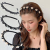 A woman models a double layer pearl and rhinestone headband worn in her hair.