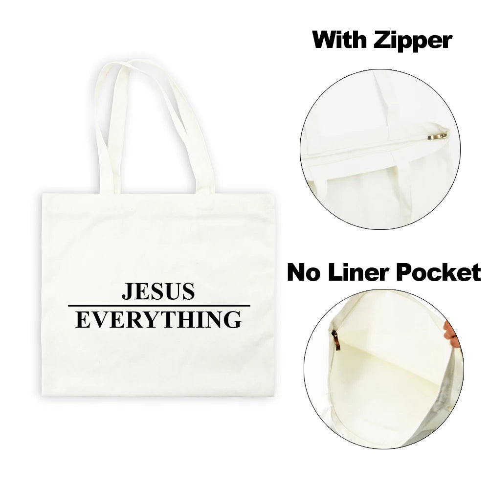 White canvas tote bag with black text Jesus Everything featuring a zipper and no liner pocket.