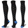 A set of multi-color compression socks featuring black fabric with scattered pink, blue, and gray dots.