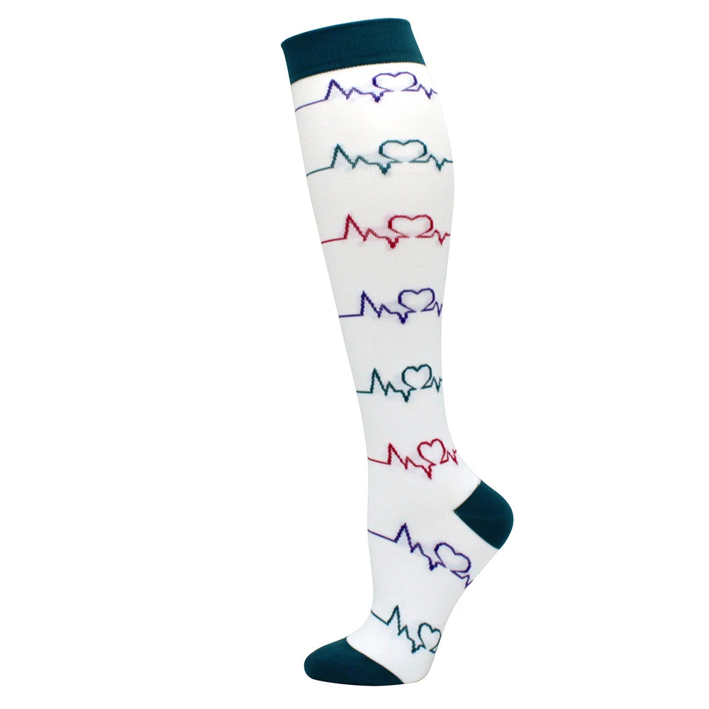 White compression socks with multicolored heart ECG line patterns and dark blue cuffs