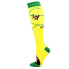 Yellow compression socks with green cuffs featuring small animal designs.