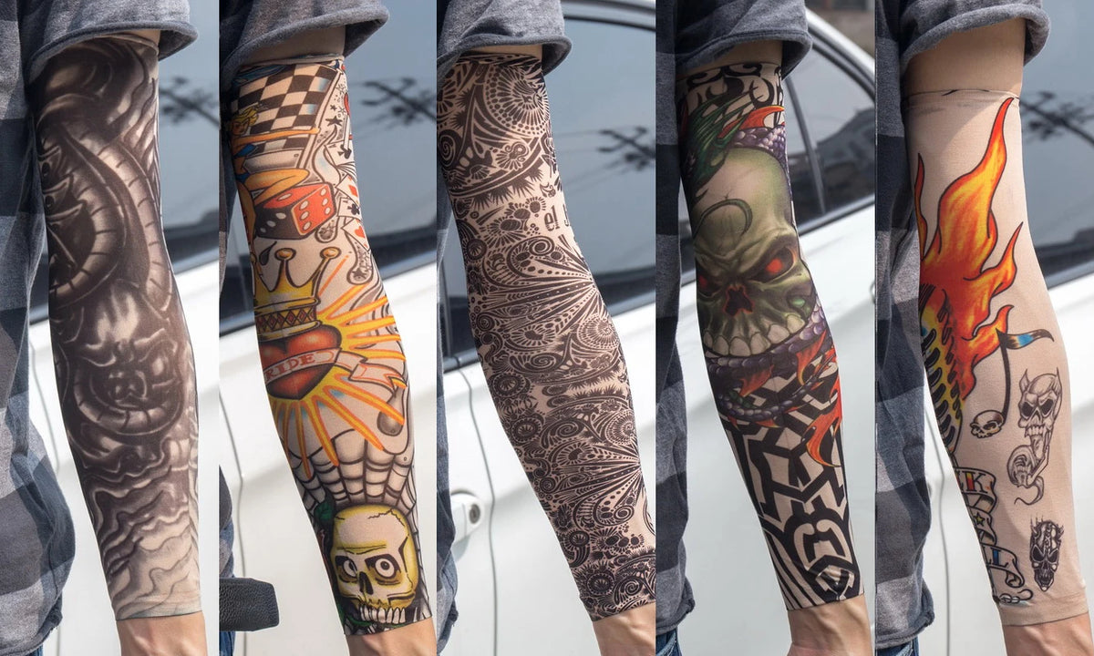 A close-up of a person wearing various reusable UV protection tattoo arm sleeves featuring detailed black and colored designs