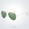 Gold-framed aviator sunglasses with olive green lenses shown from the side.