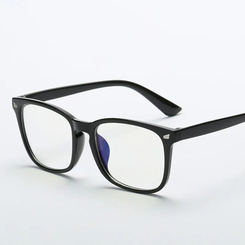 A pair of black square full frame optical glasses with a purple lens resting on a white background.