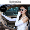A woman wearing white fingerless arm sleeves is driving a car, demonstrating sun protection.