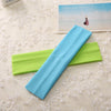 A light blue elastic headband is displayed next to a lime green one on a white lace surface.