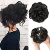 A woman shows off messy curly hair bun extensions styled in an updo and a loose bun.