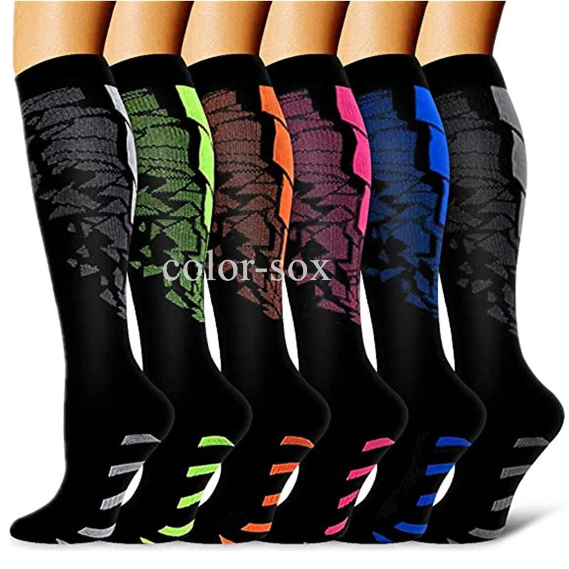 A row of graduated compression socks in various colors, including black, green, orange, purple, and blue.