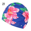 A vibrant blue swimming cap featuring a floral pattern of pink and green flowers.