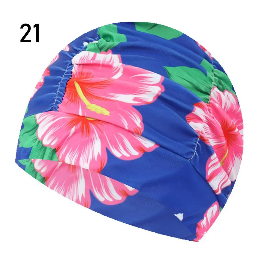 A vibrant blue swimming cap featuring a floral pattern of pink and green flowers.