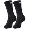 A pair of black performance cycling and sports socks shown standing upright.