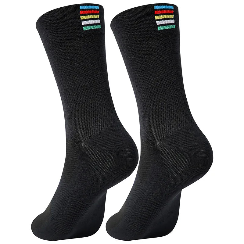 A pair of black performance cycling and sports socks shown standing upright.