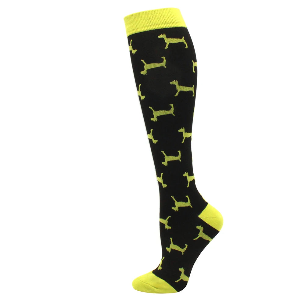 Black compression socks with yellow trim featuring a repeating silhouette pattern.