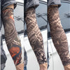 Close-up of a person wearing black and gray reusable UV protection tattoo arm sleeves with intricate designs.