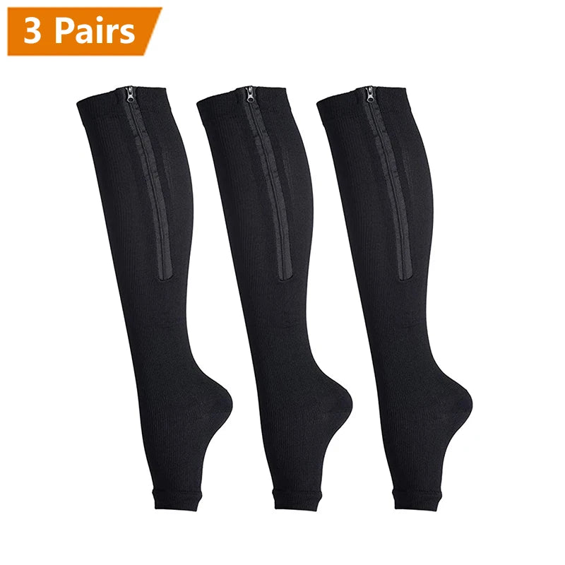 Three pairs of black zipper compression socks displayed against a white background.