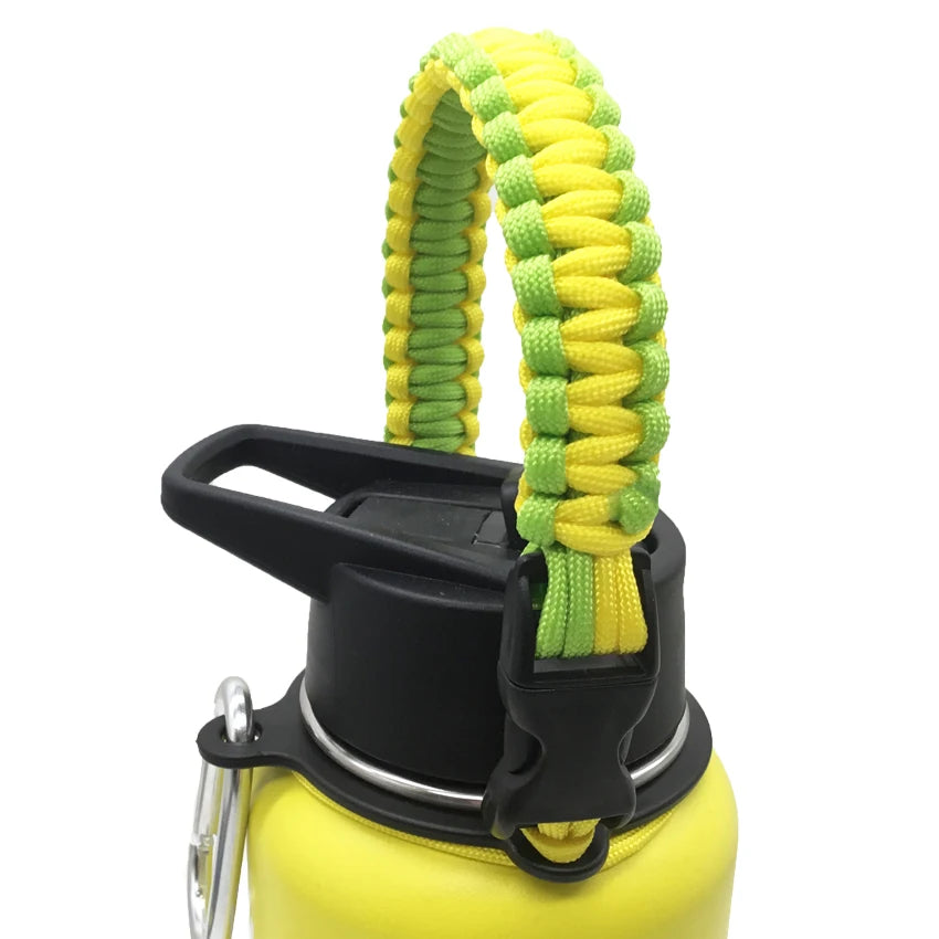 A yellow water bottle with a black strap made of green and yellow paracord.