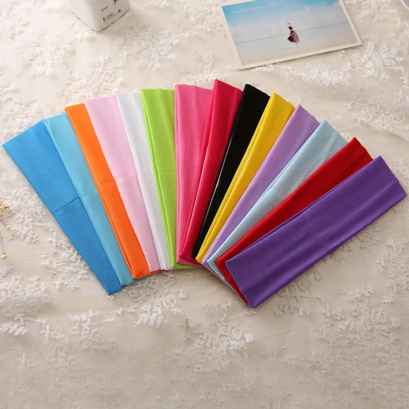 A colorful display of multi-use elastic headbands in various shades including blue, orange, pink, green, yellow, and purple.