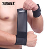 Black cotton elastic wrist straps being worn on a person's arm for support.
