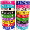 A stack of silicone religious cuff bracelets in various colors, featuring the text JESUS LOVES YOU.