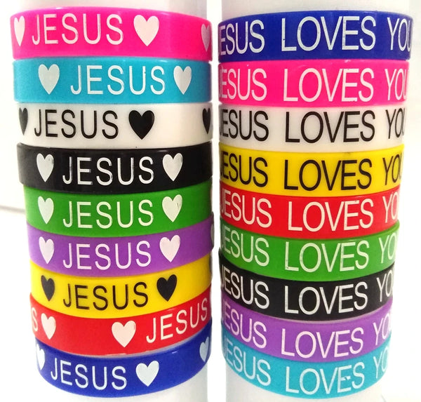 A stack of silicone religious cuff bracelets in various colors, featuring the text JESUS LOVES YOU.