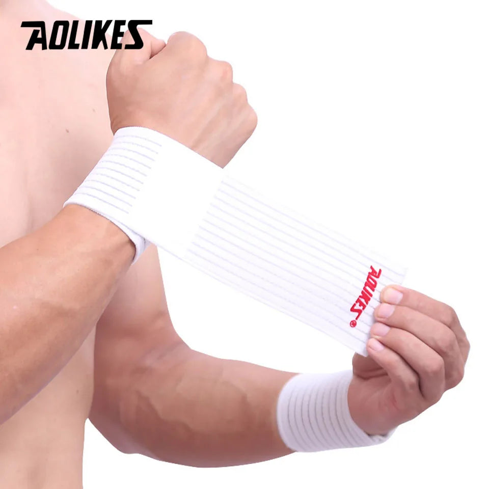 A hand is wearing a white elastic wrist strap for sports and daily support.