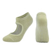 A pair of light olive green breathable women's Pilates and yoga socks shown from the side.