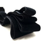 Black stretch velvet elastic headbands folded and displayed on a white background.
