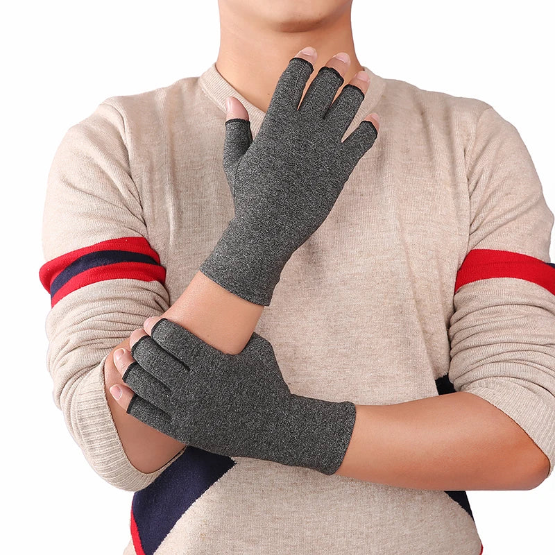 A person wearing beige long sleeves and wrist gloves with red and blue accents.