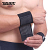 Black elastic wrist straps being worn on a person's forearm for support.