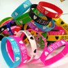 A collection of colorful silicone religious cuff bracelets in various shades including blue, green, pink, and red.