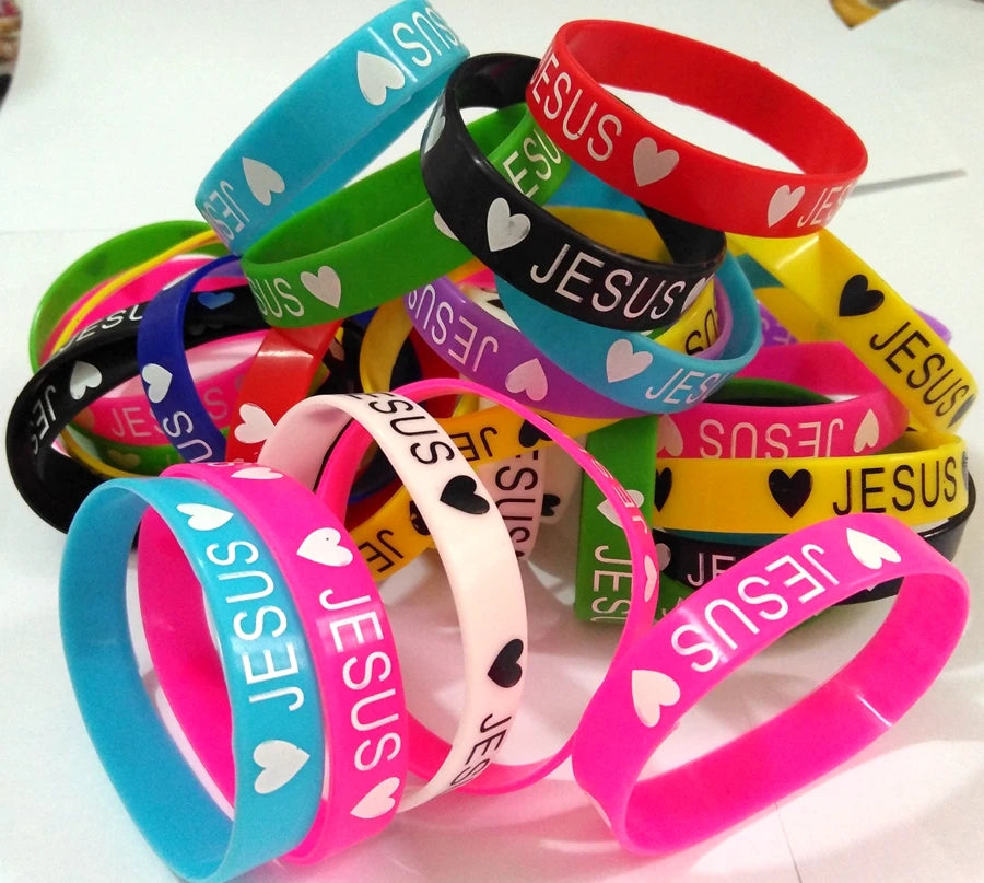 A collection of colorful silicone religious cuff bracelets in various shades including blue, green, pink, and red.