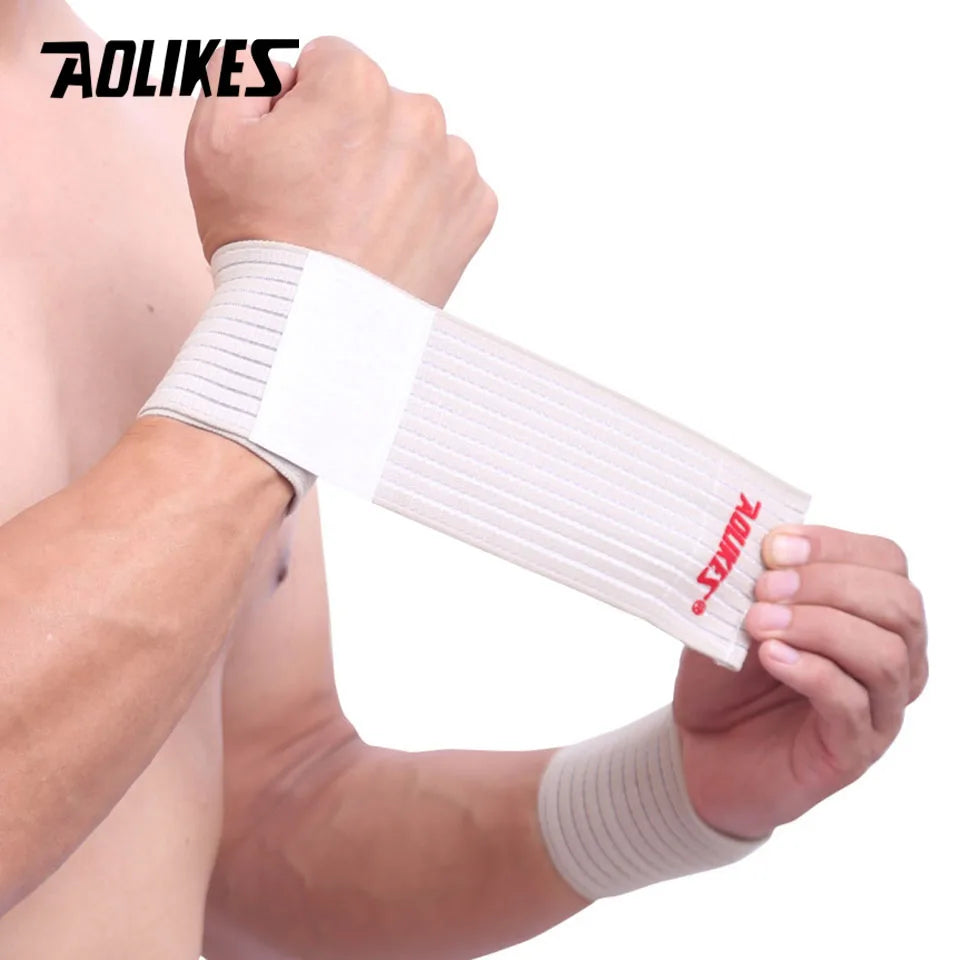 A hand is wearing a white elastic wrist strap for sports and daily support.