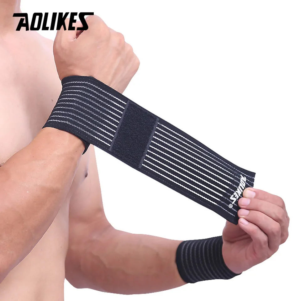 Black elastic wrist strap with ribbed texture worn on a person's forearm for support