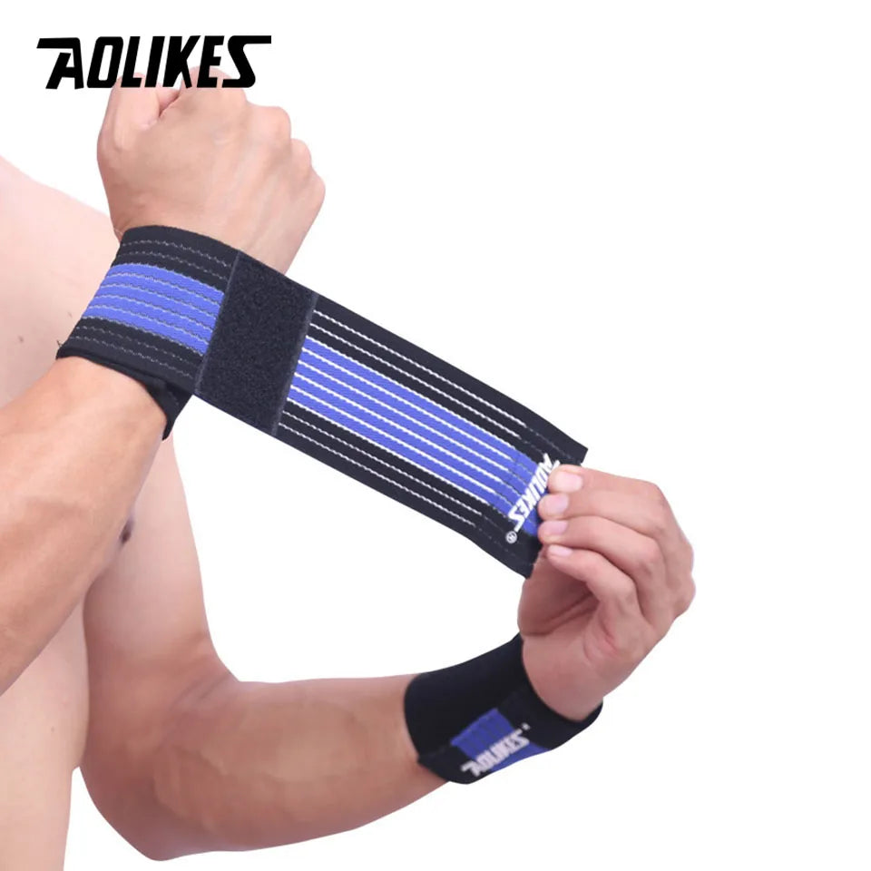 Black and blue elastic wrist straps being worn on a person's arm for support.