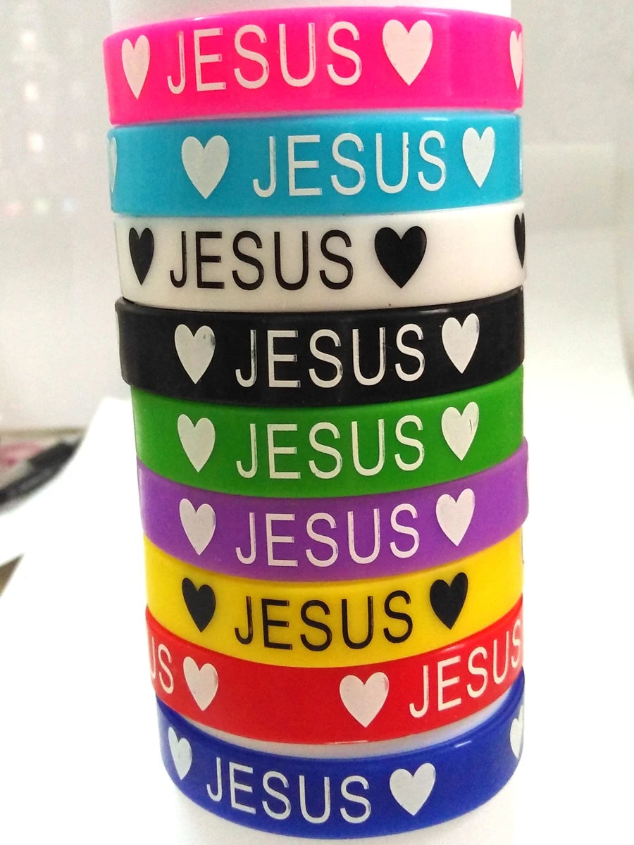 A stack of colorful silicone cuff bracelets with the word JESUS written on each band.