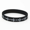 Black silicone cross wristband with white decorative crosses.