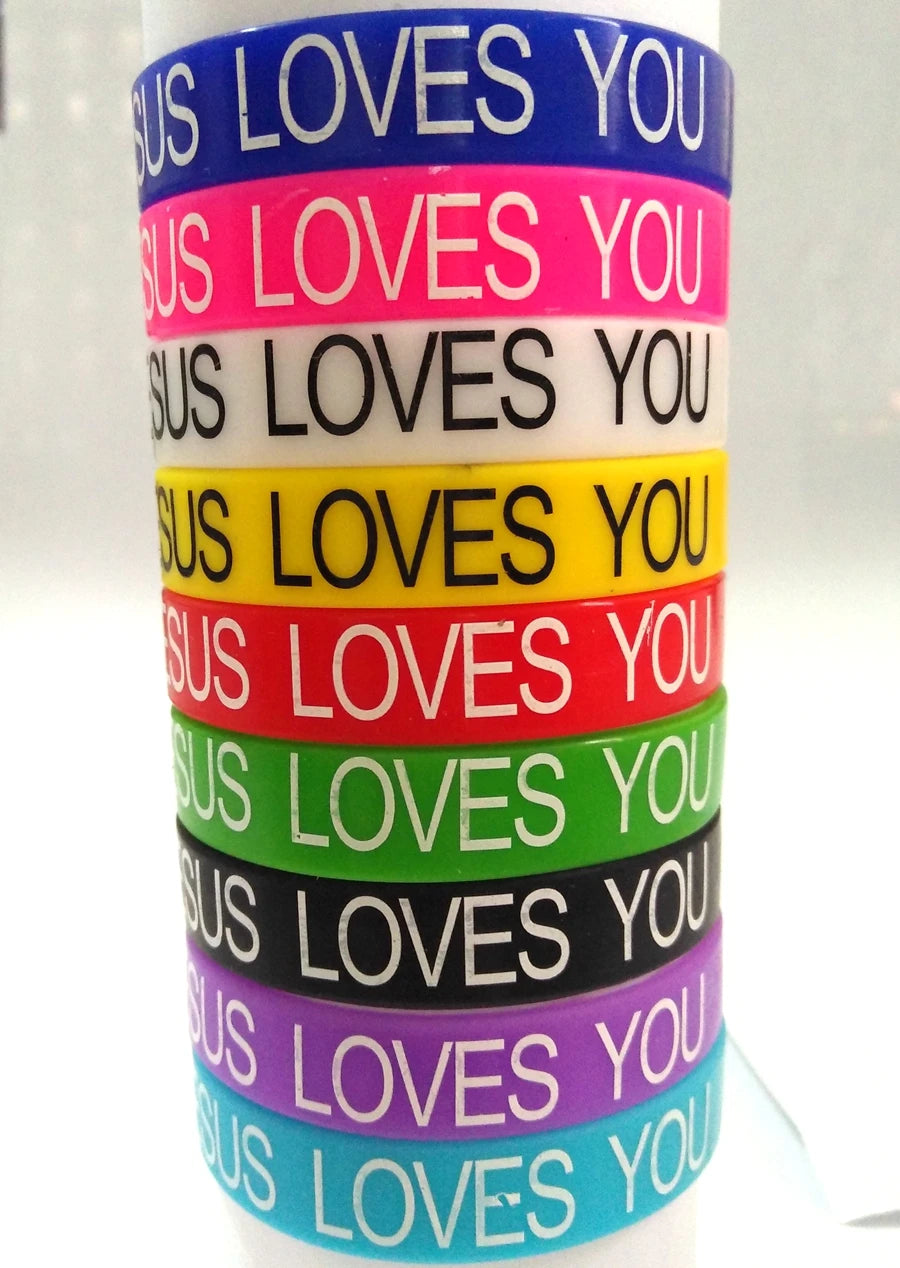 A stack of colorful silicone religious cuff bracelets in various shades of blue, pink, yellow, red, green, black, and purple.