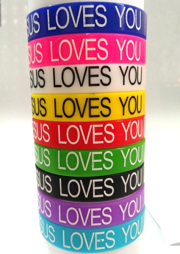 A stack of colorful silicone religious cuff bracelets in various shades of blue, pink, yellow, red, green, black, and purple.