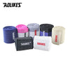 A collection of various colored cotton elastic wrist straps for sports and daily support.