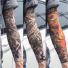 A close-up of a person wearing colorful, detailed tattoo arm sleeves for UV protection.