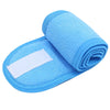 A bright blue absorbent towel rolled up and placed on a light blue silicone headband.
