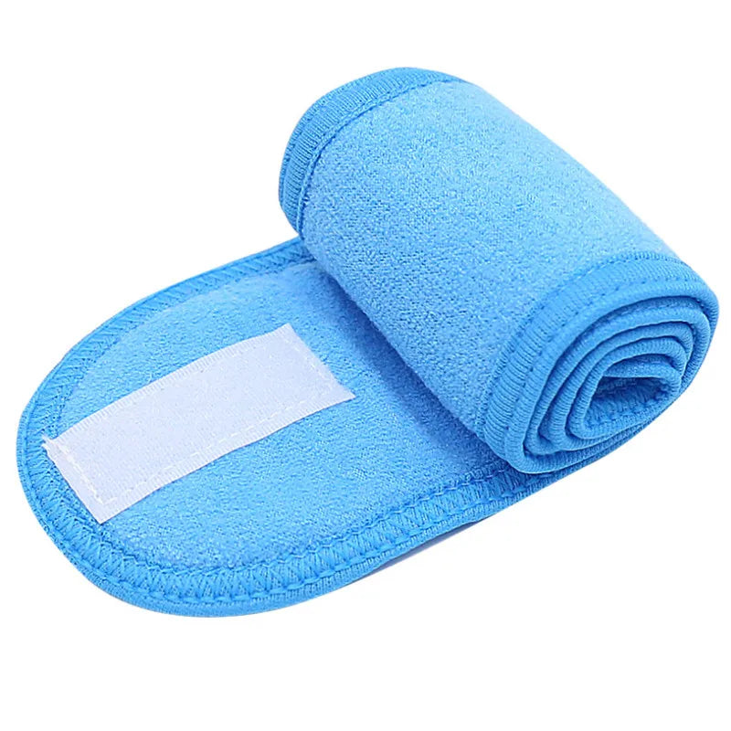 A bright blue absorbent towel rolled up and placed on a light blue silicone headband.
