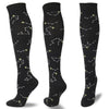 Black compression socks featuring a pattern of gold and white star constellations