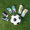 A collection of nine soccer shin guards featuring different player names and numbers on a green turf background.