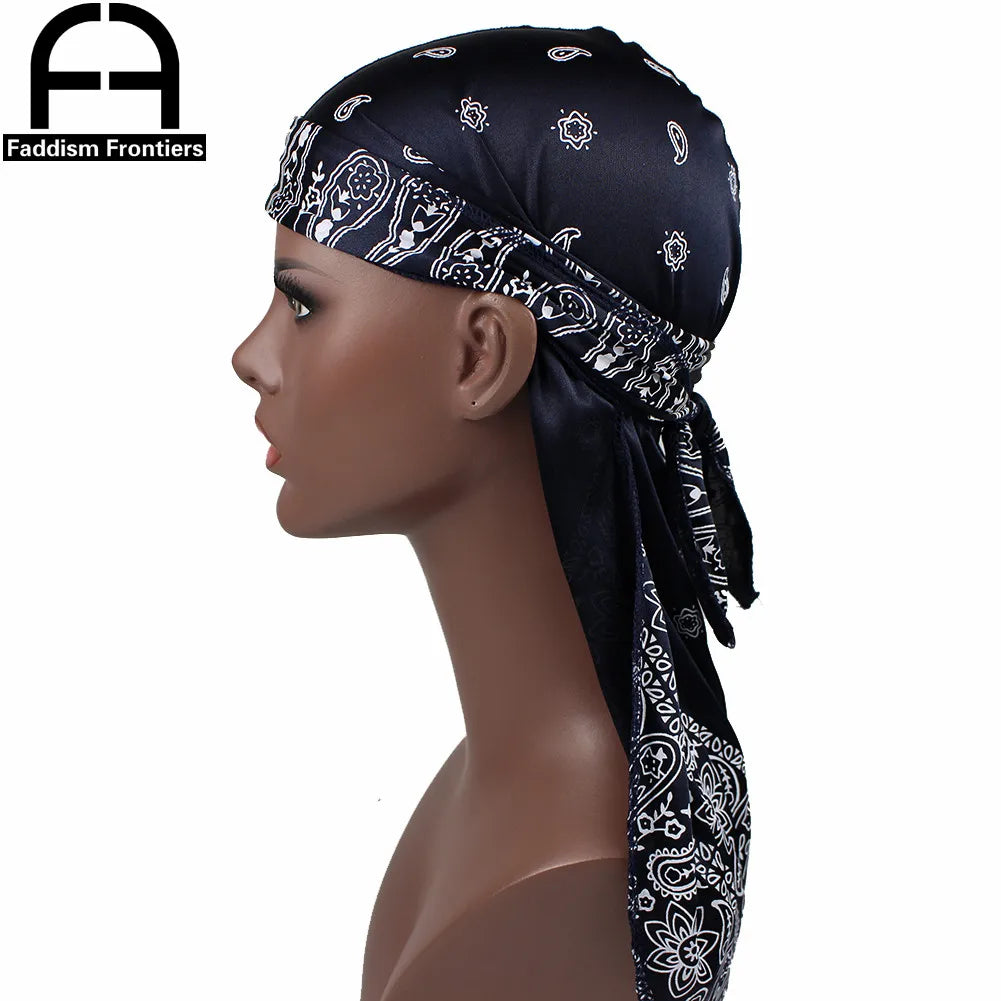 Model wearing a black silk paisley durag headscarf with white embroidery