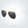 Gold-framed aviator sunglasses with dark lenses shown in a studio setting.